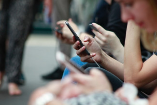People browsing on cell phones at Bath, United Kingdom, Credits: Robin Worrall on Unsplash